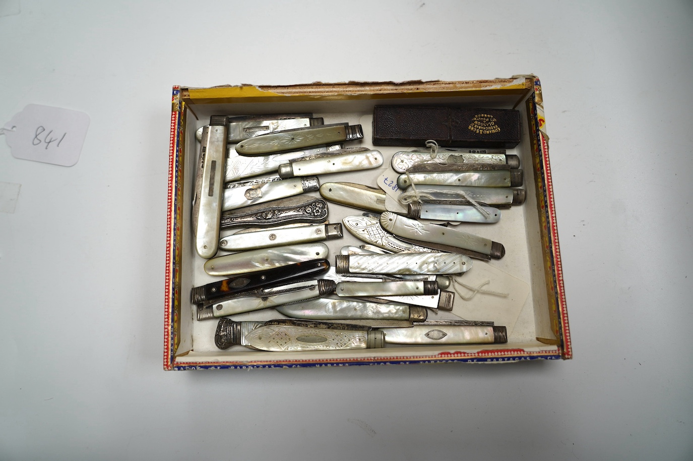 A collection of twenty two assorted mainly Victorian mother of handled silver fruit knives, one with leather case, together with a similar sterling knife and four Georgian silver travelling forks, three with mother of pe